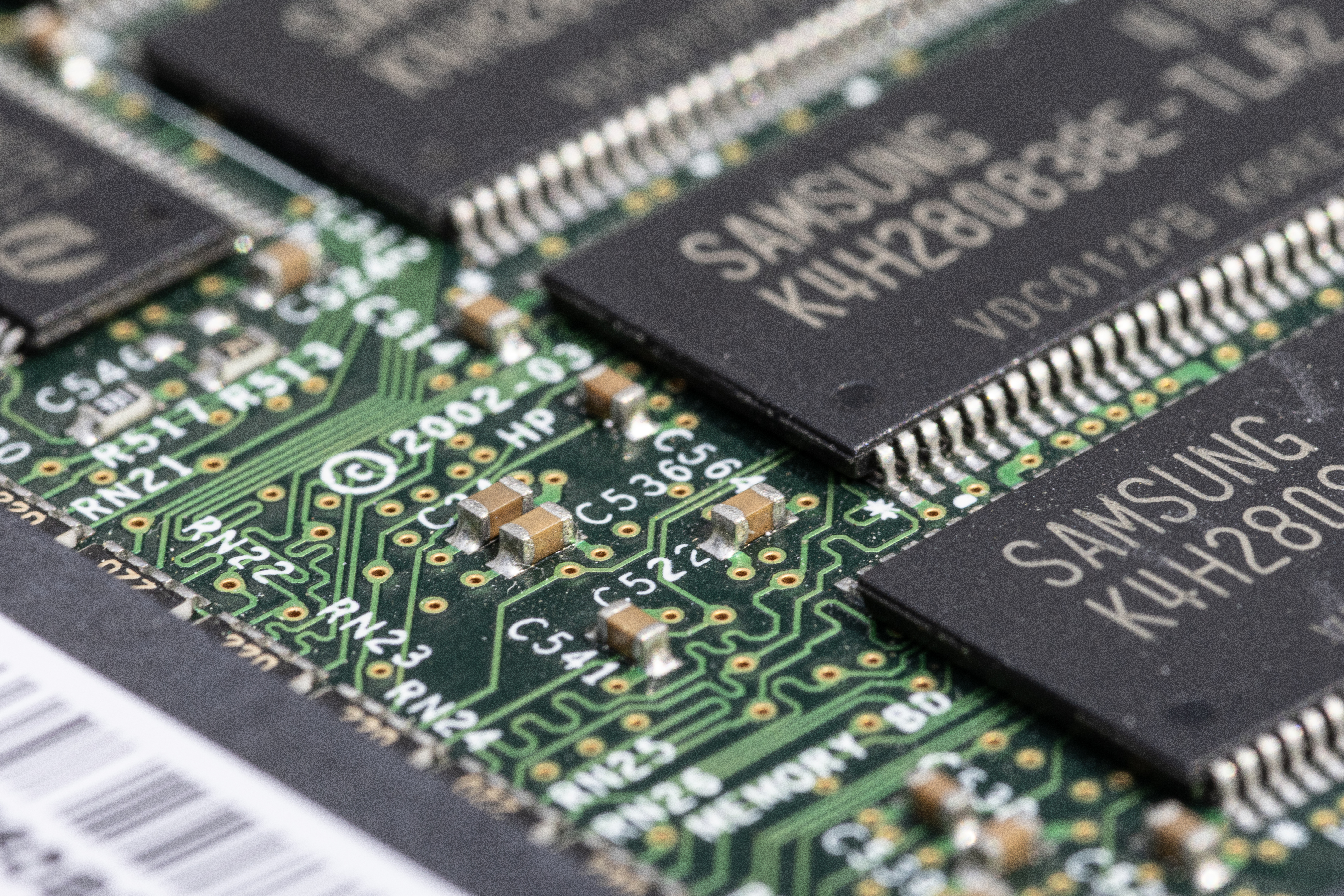 Computer motherboard with miniature technicians working on CPU socket